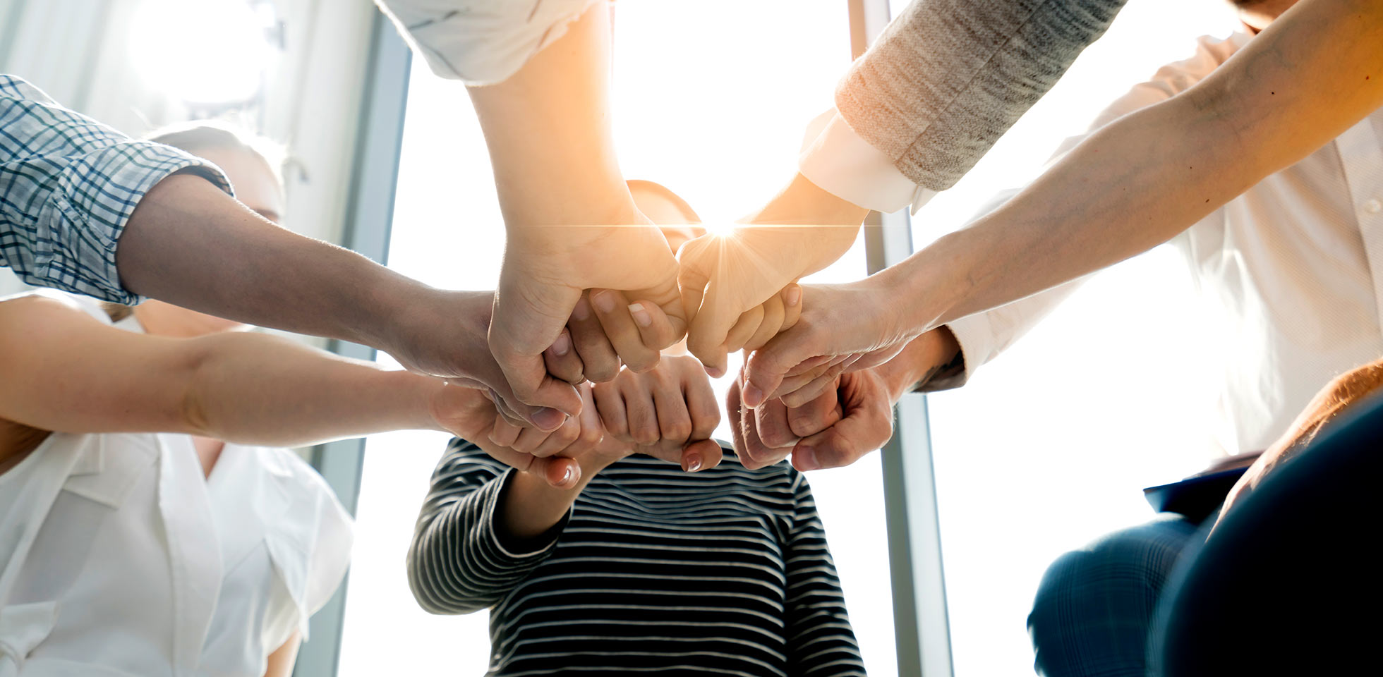 Close up top view of young and freshness energy business people putting their strong hands together. Stack of friendship hands. Unity and successful teamwork concept.